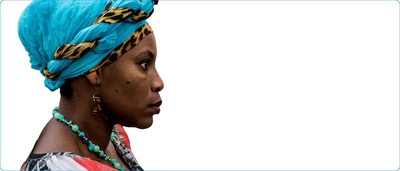 Mujer afrodescendiente de perfil, con turbante turquesa y collar de cuentas verdes.